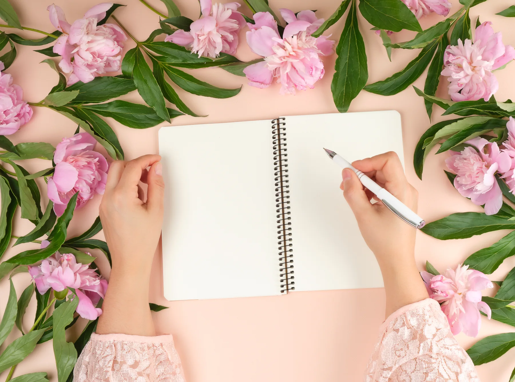 libro-vacio-blanco-escribiendo-boli-flores-alrededor